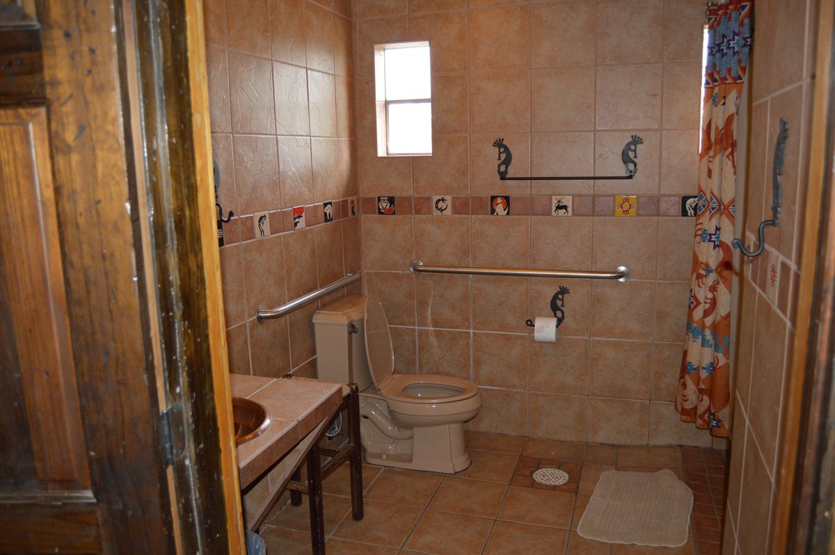 A bathroom with a toilet , sink , and shower.