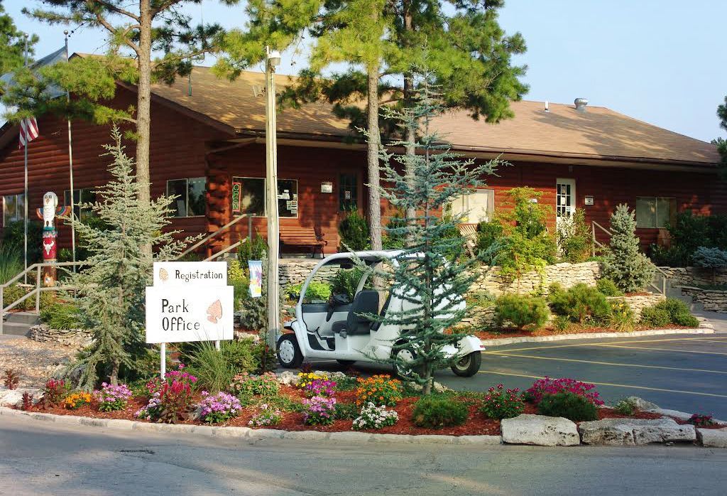 A golf cart is parked in front of a building