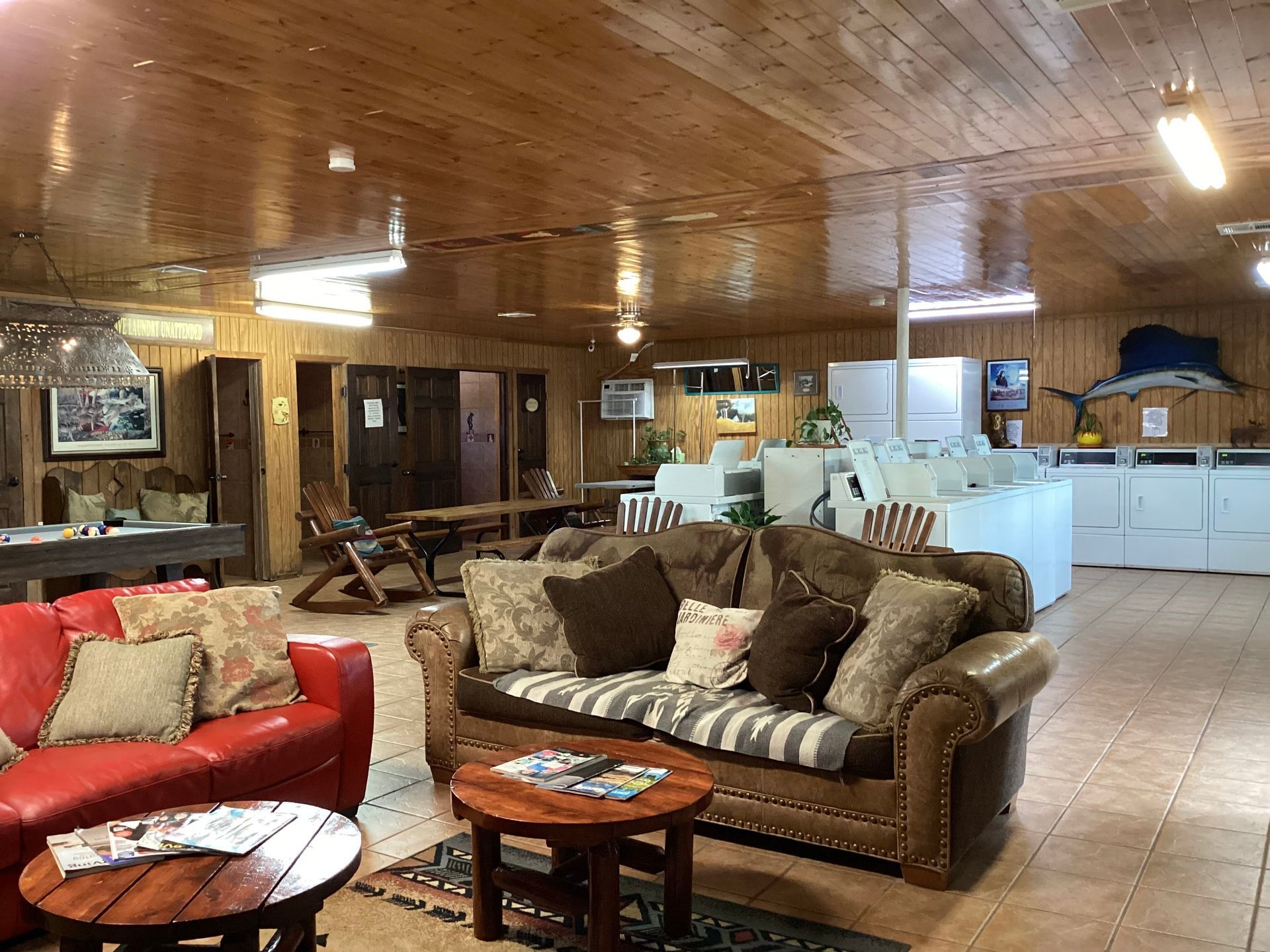 A living room with a red couch and a brown couch