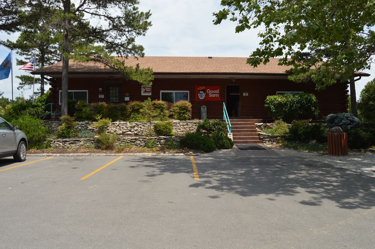 A car is parked in front of a large building.