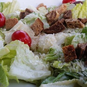 Caesar salad with romaine, croutons, cherry tomatoes, and creamy dressing
