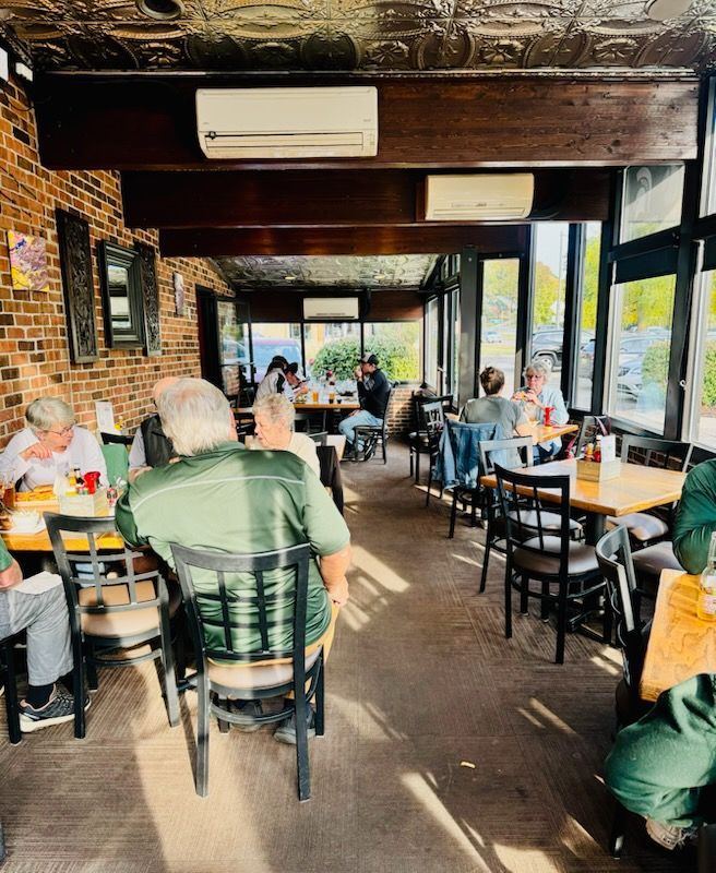 A plate of food with a bottle of harrison road house in the background