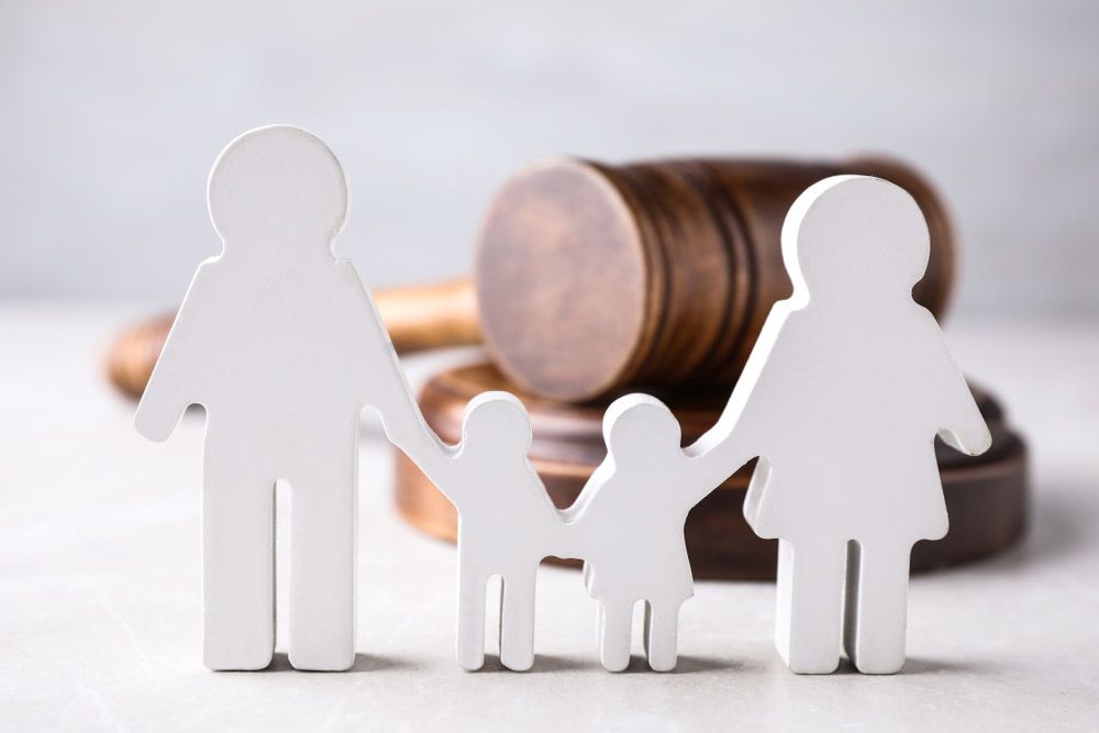 Figure In Shape People And Wooden Gavel On Light Table — Legal & Family Law in Grafton, NSW