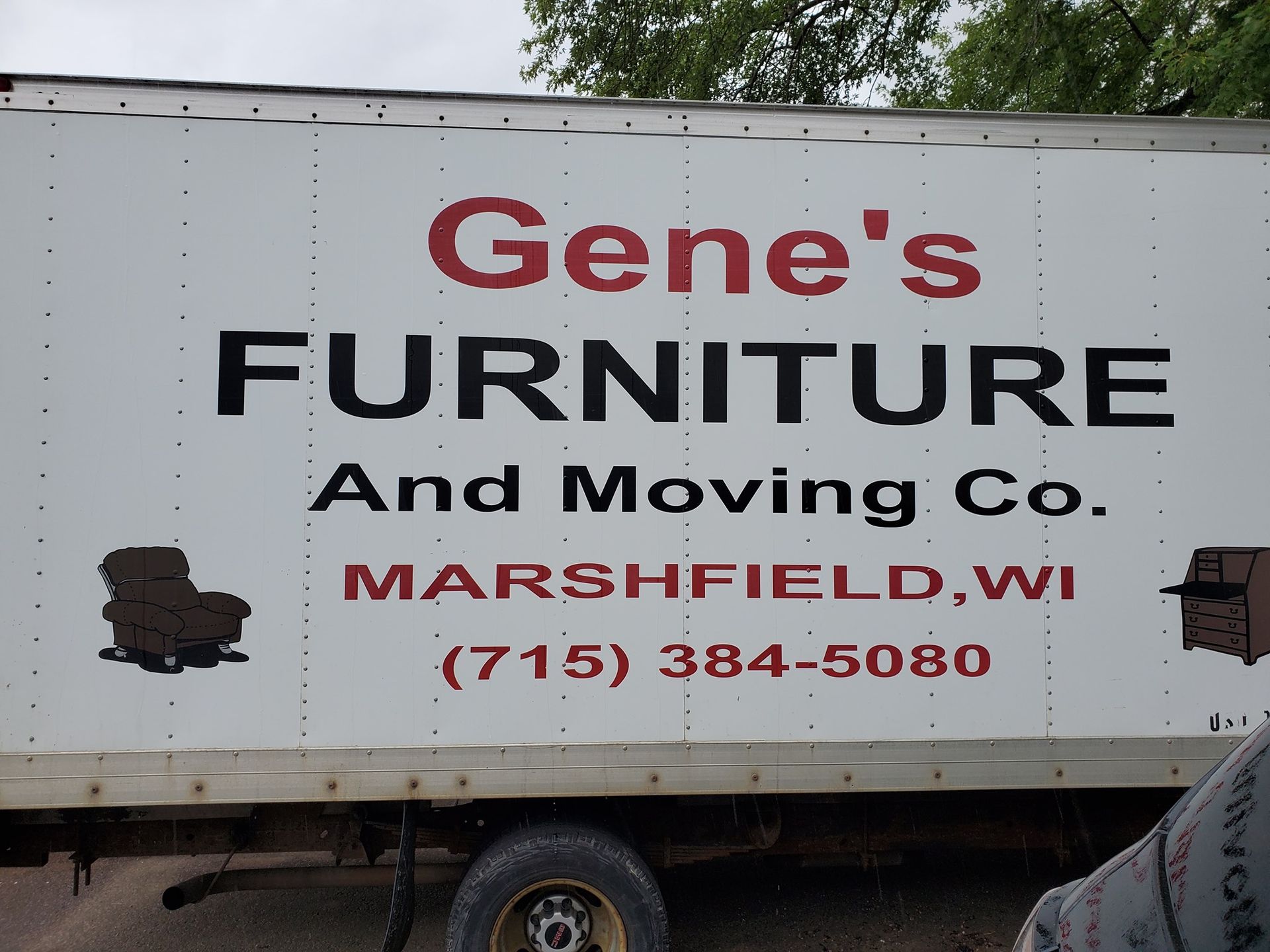 A family is moving into a new home and carrying boxes.