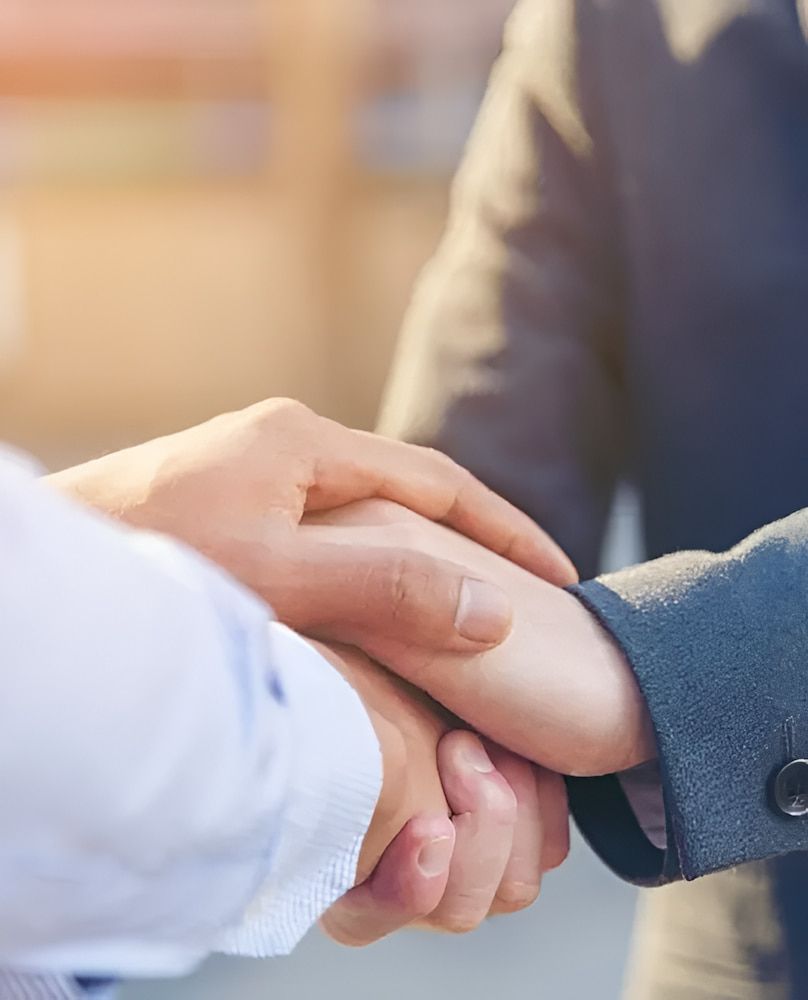 Two People Shaking Hands, Sealing a Deal or Agreement, Outdoors — Bradley Solicitors in Larrakeyah, NT