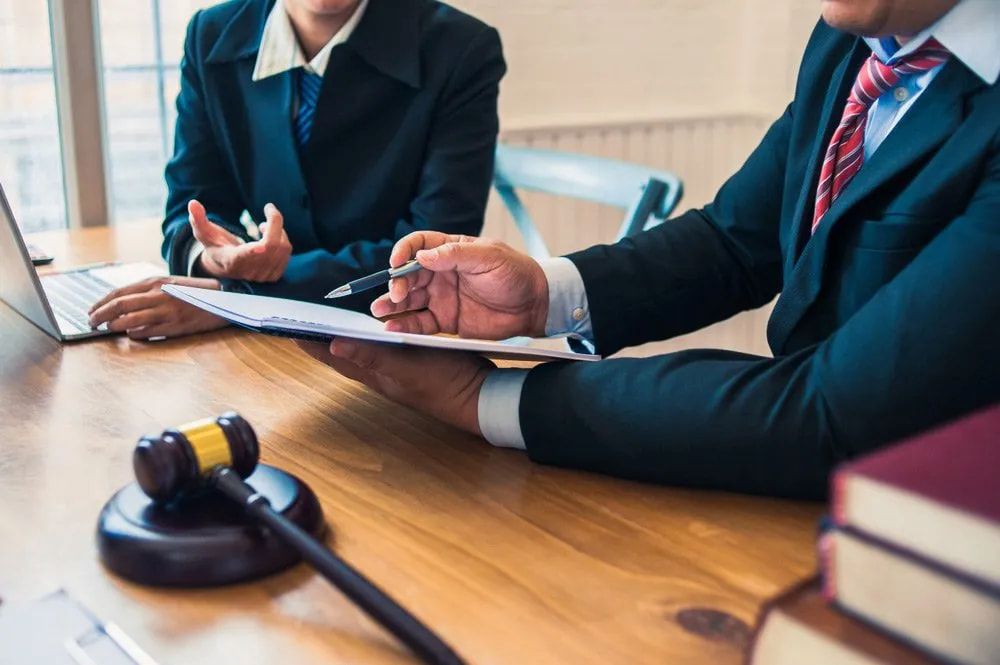 Lawyers Reviewing Documents at a Table — Bradley Solicitors in Larrakeyah, NT