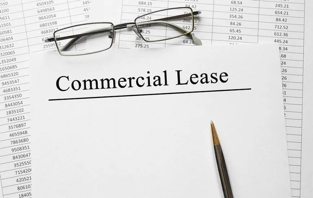 Commercial Lease Document With Glasses and Pen on Top of a Spreadsheet — Bradley Solicitors in Larrakeyah, NT