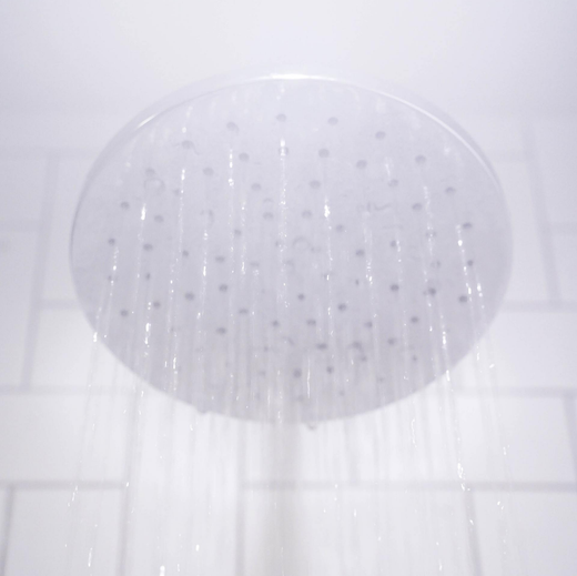 white shower head pouring water