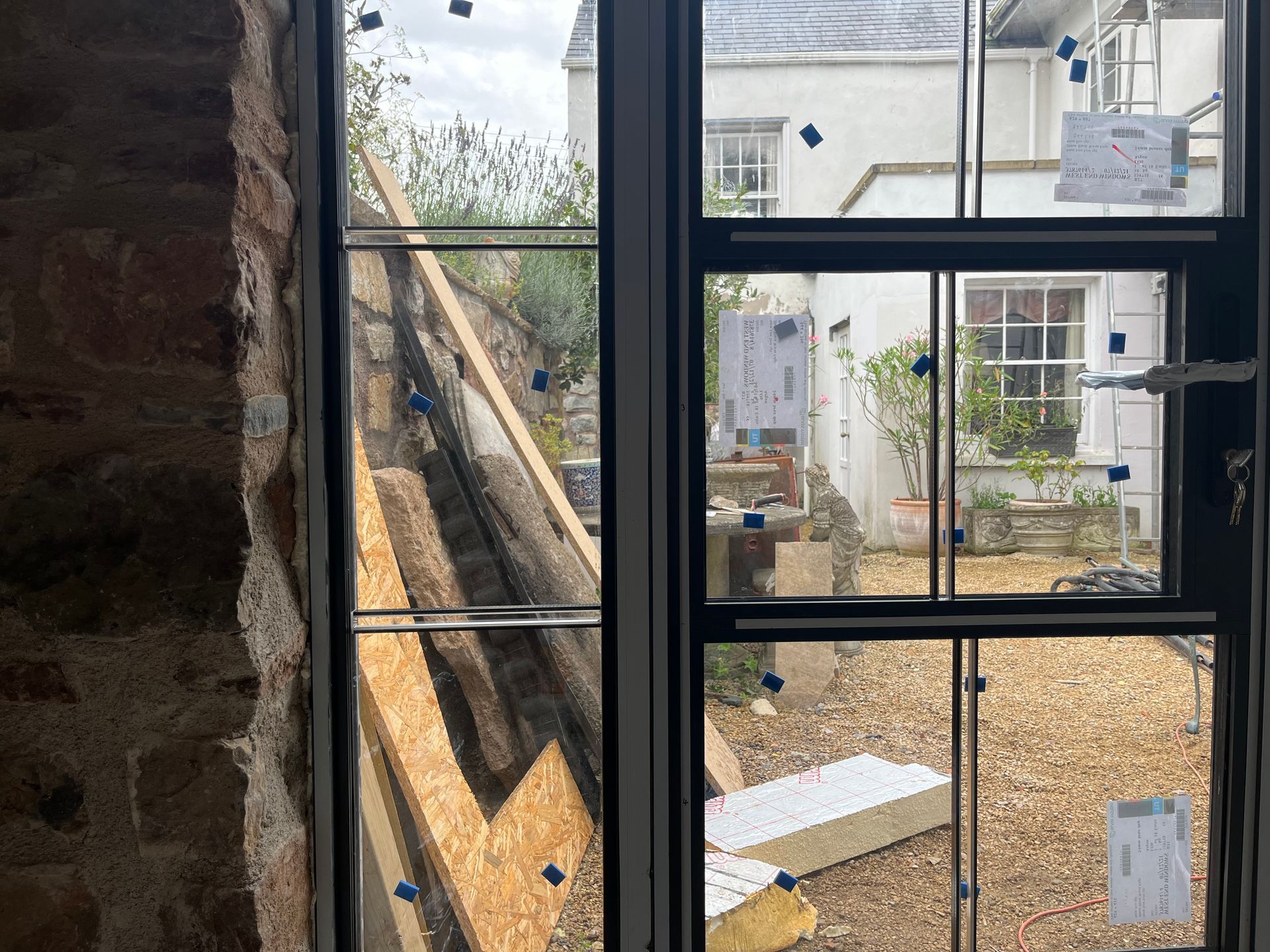 A window with a lot of glass is being installed in a building.
