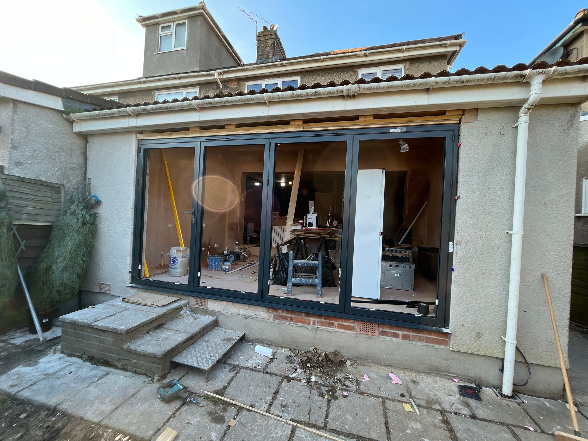 A house is being remodeled with sliding glass doors.