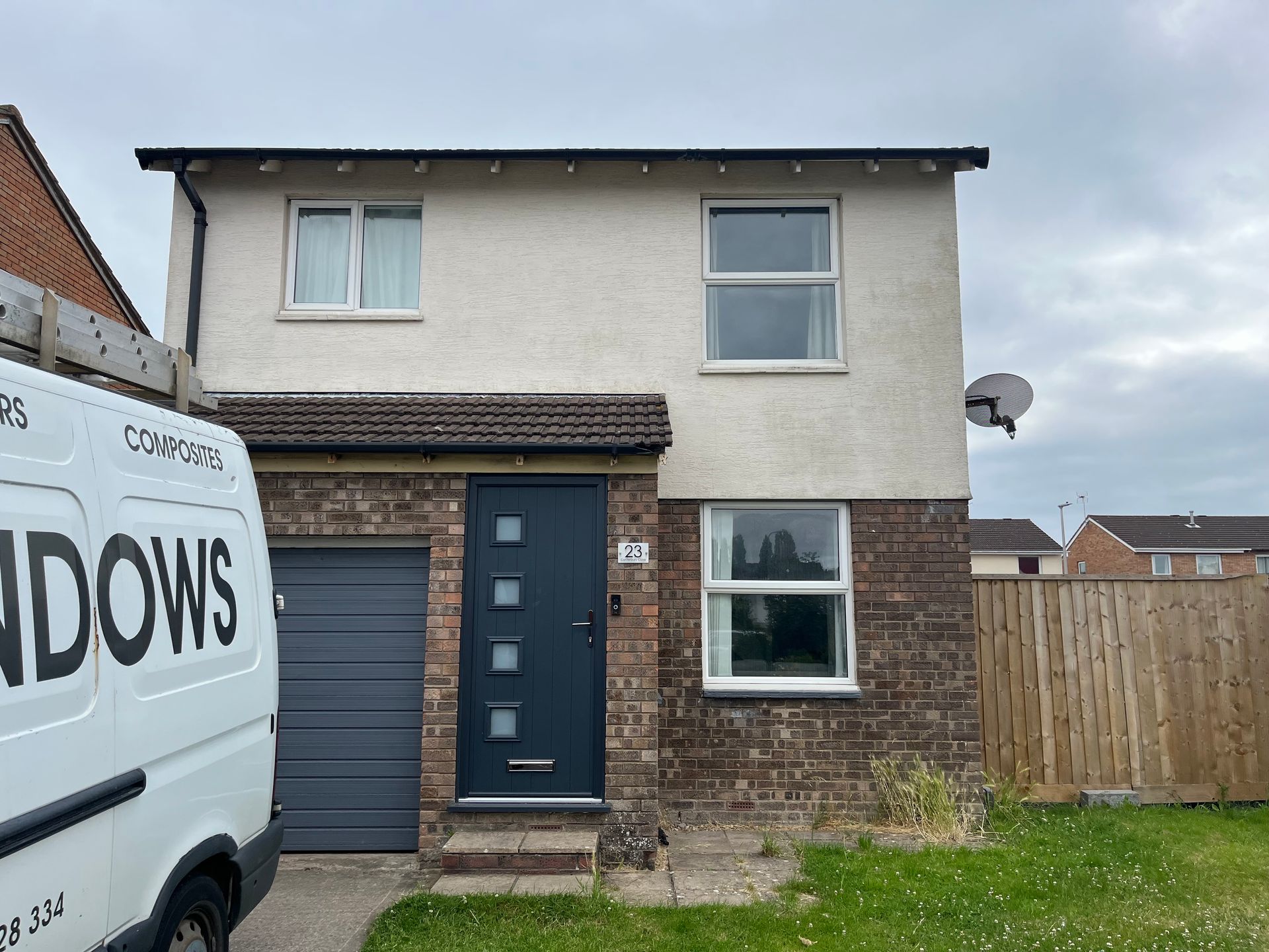 A white van is parked in front of a house.