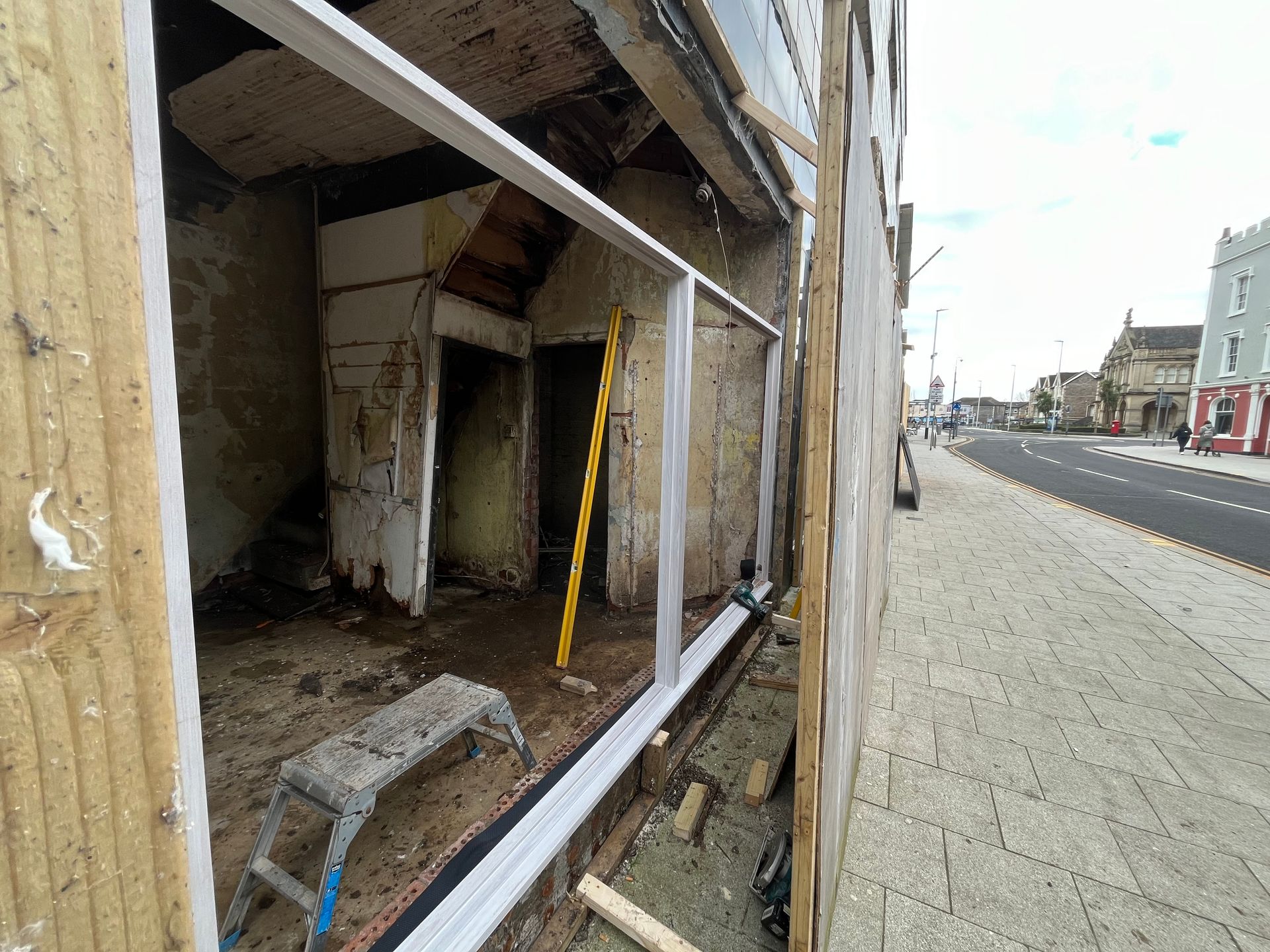 A building that is being remodeled with a ladder in front of it