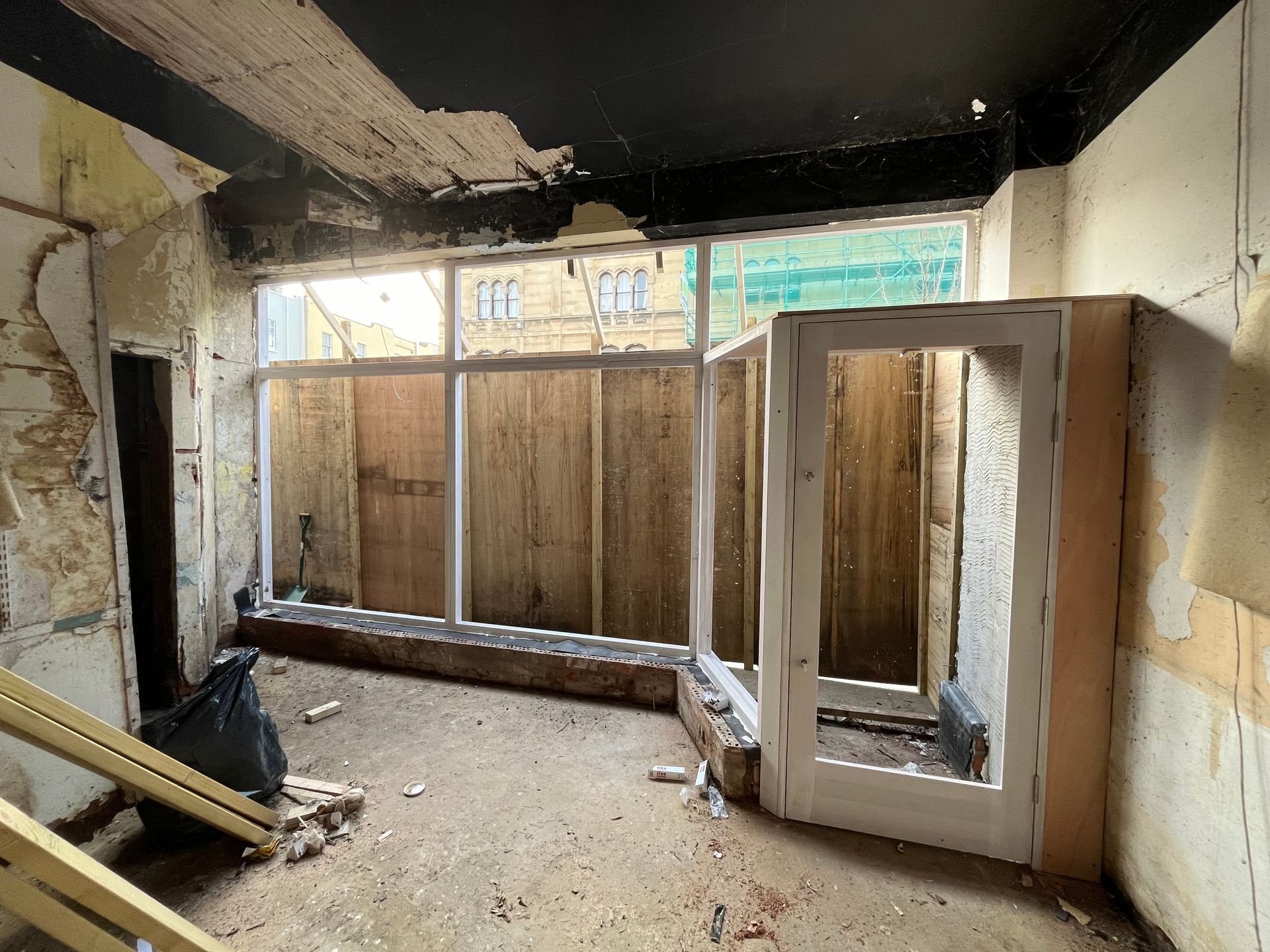 A room with a lot of windows and a door.