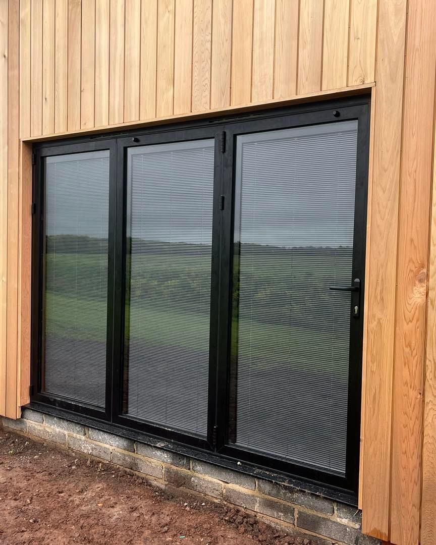 A large window on the side of a wooden building.