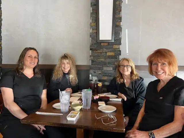 A group of women are sitting at a table in a restaurant.