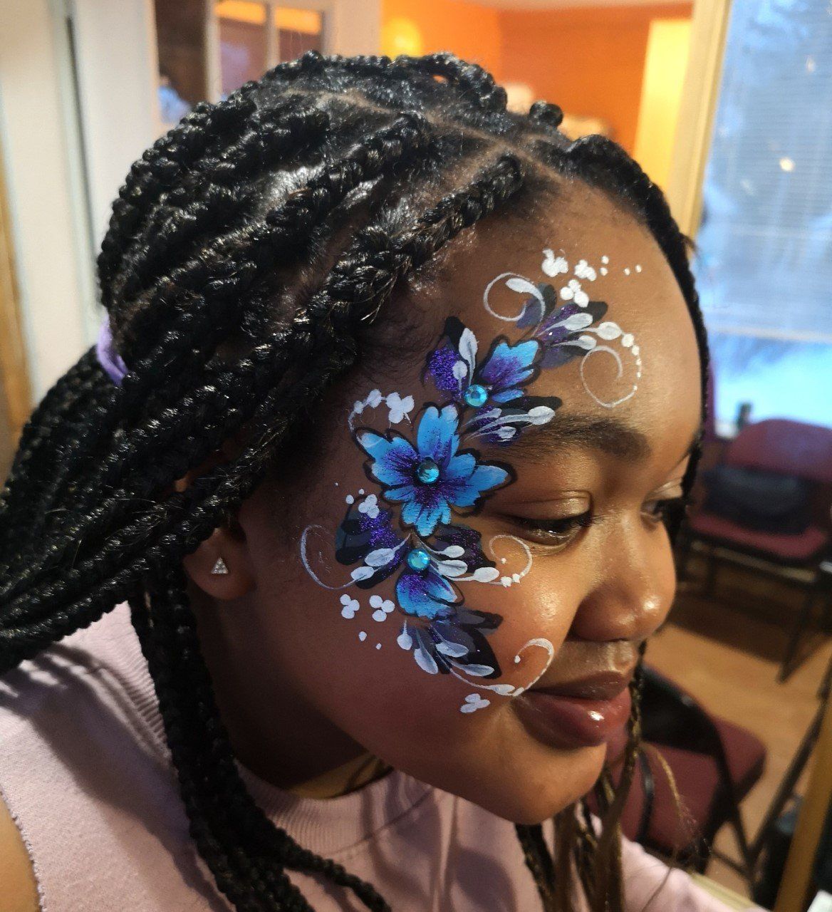 Flower face painting design near the eyes.  Kids celebration