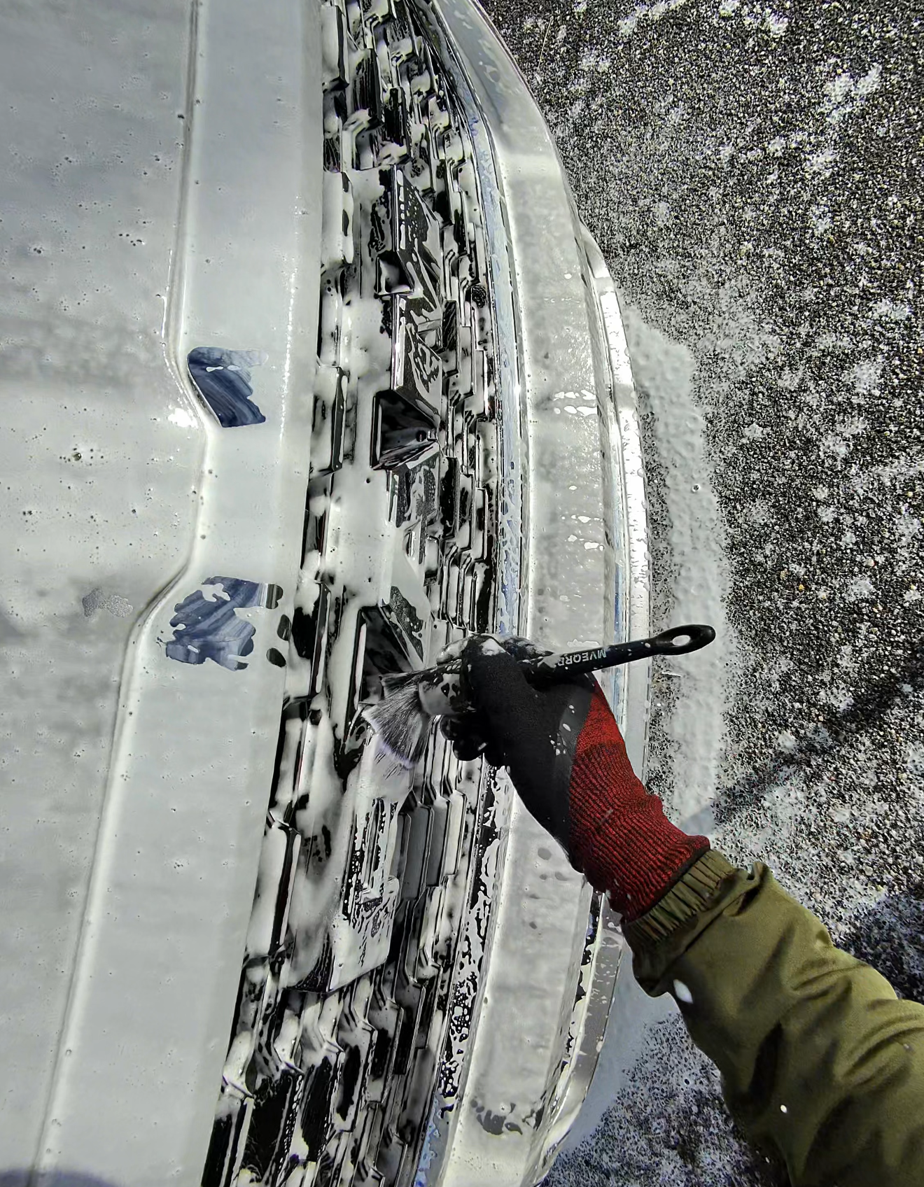 A person is cleaning the interior of a car with a spray bottle.