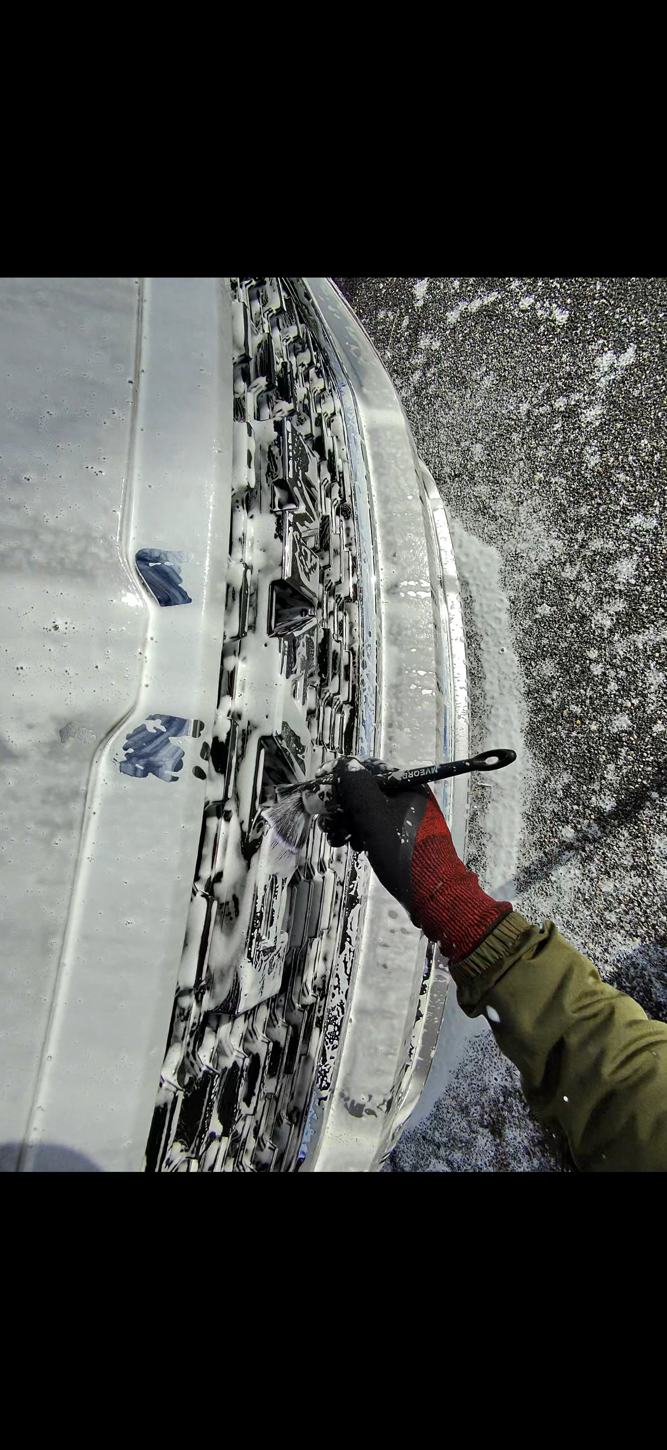 A close up of a black car 's headlight