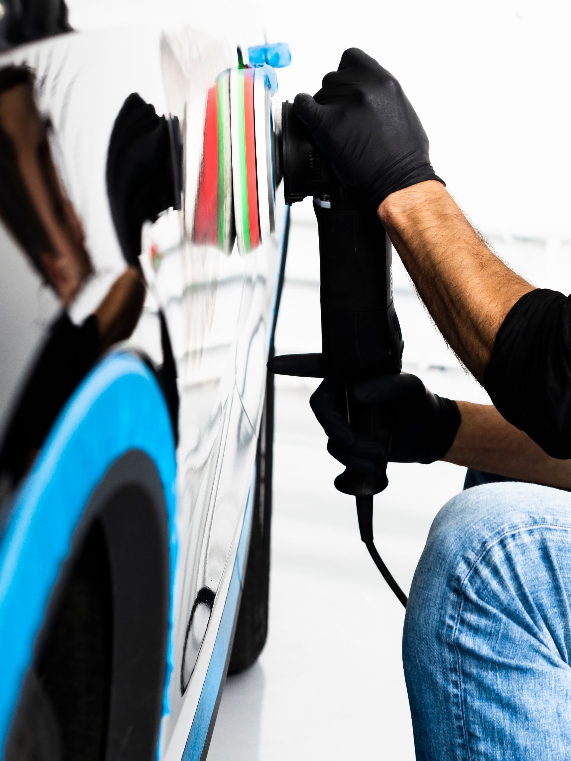 A man is polishing a car with a machine
