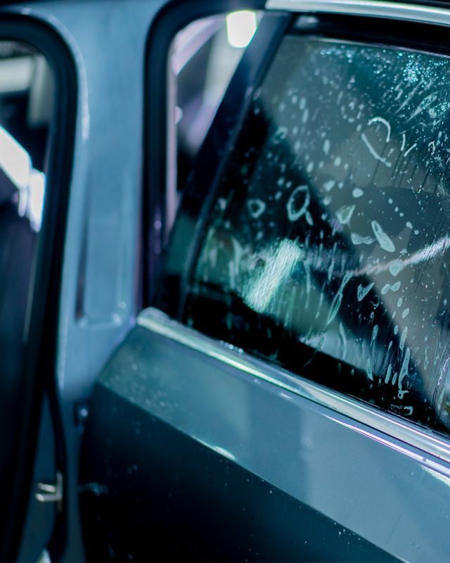 A close up of a car window with a sticker on it.