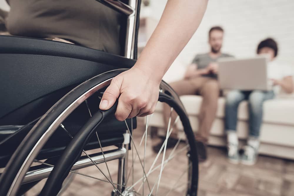 A person in a wheelchair is holding the wheel.