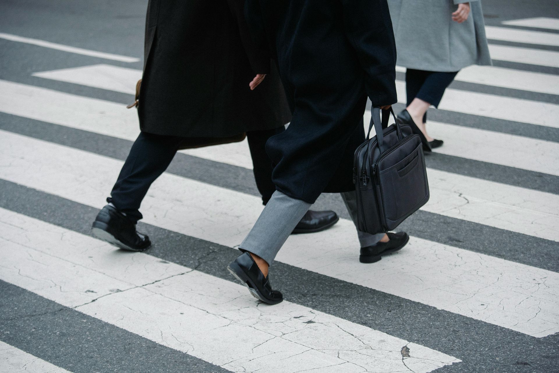A group of people are walking across a crosswalk.