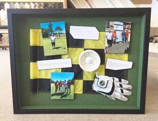 Framed shadowbox of golf items