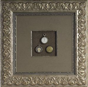 Framed antique pieces in a shadowbox