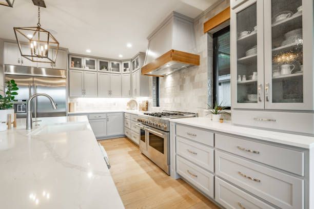 A kitchen with white cabinets and stainless steel appliances.
