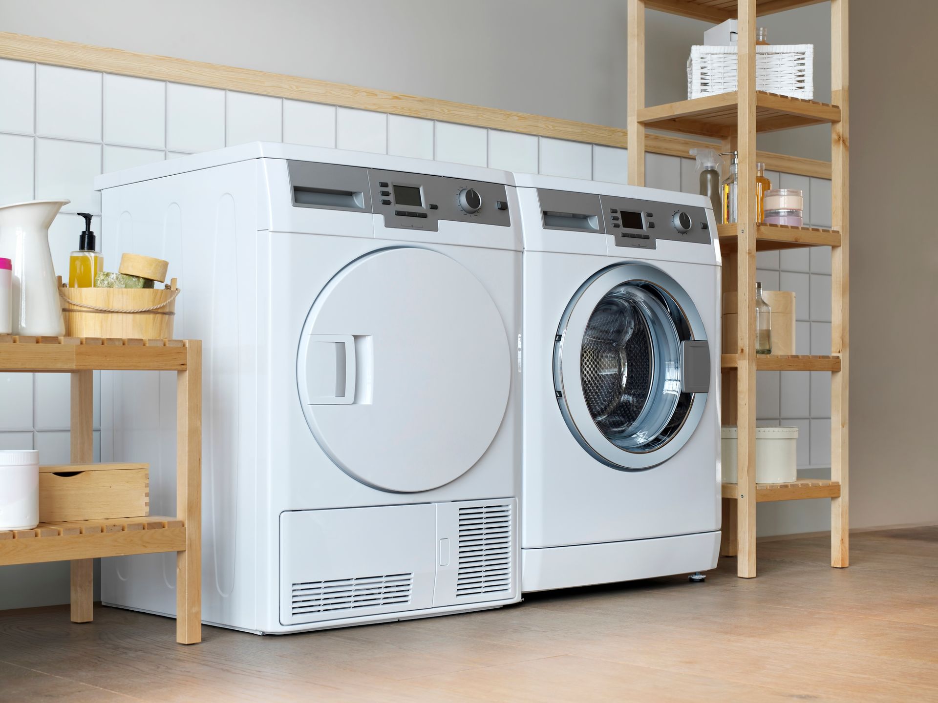 A washer and dryer are sitting next to each other in a laundry room.