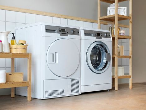 A washer and dryer are sitting next to each other in a laundry room.
