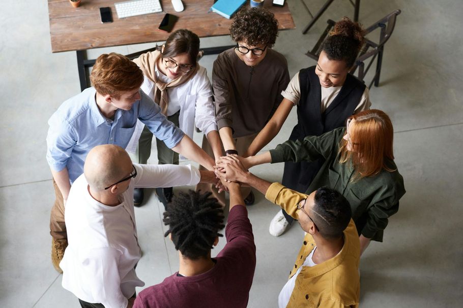 International hospitality team united with hands together in a circle