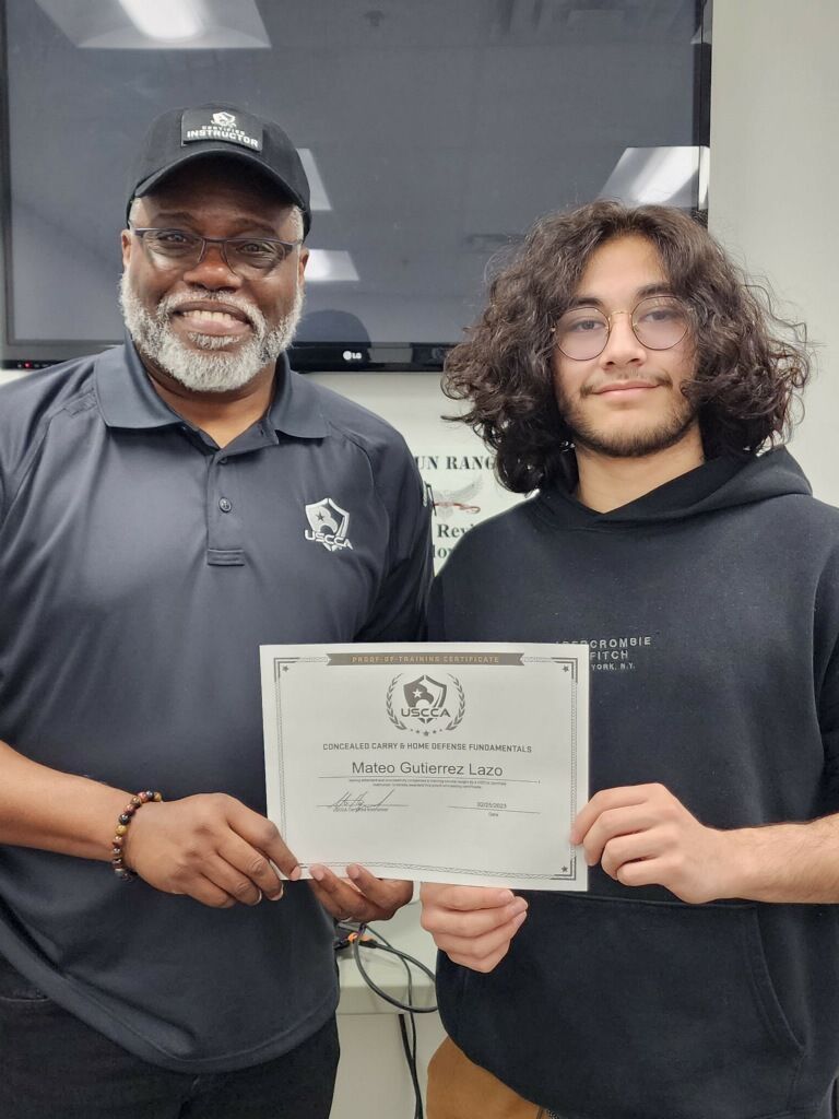 Man presents certificate to smiling teen. White background, indoor.