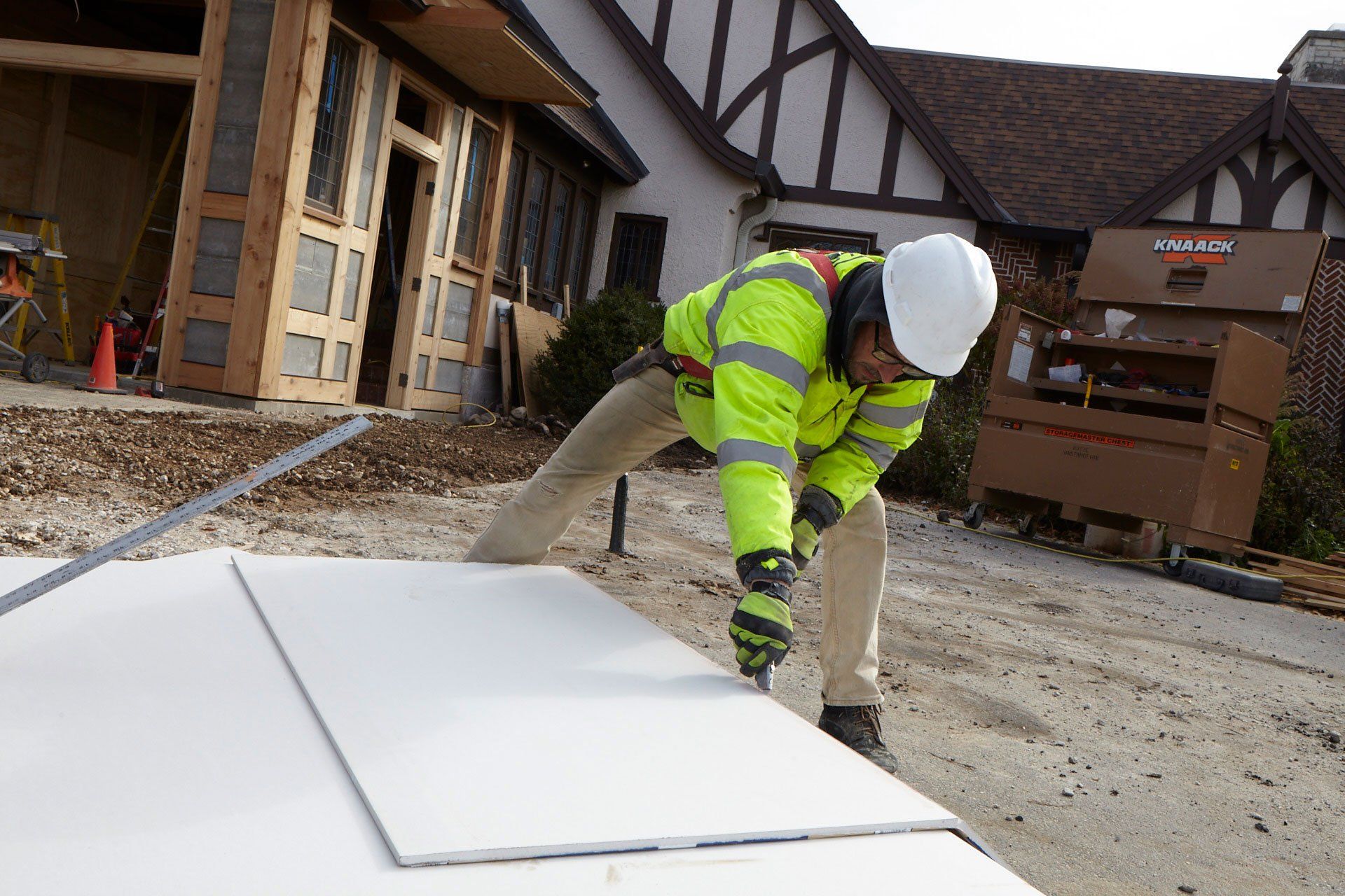 Worker Cutting Tiles for Construction ─ Milwaukee, WI ─ Kotze Construction Co., Inc.