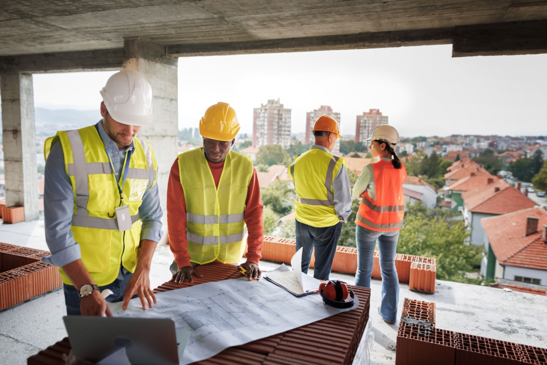 Colleagues analyzing project on construction site - Milwaukee, WI - Kotze Construction Co., Inc.