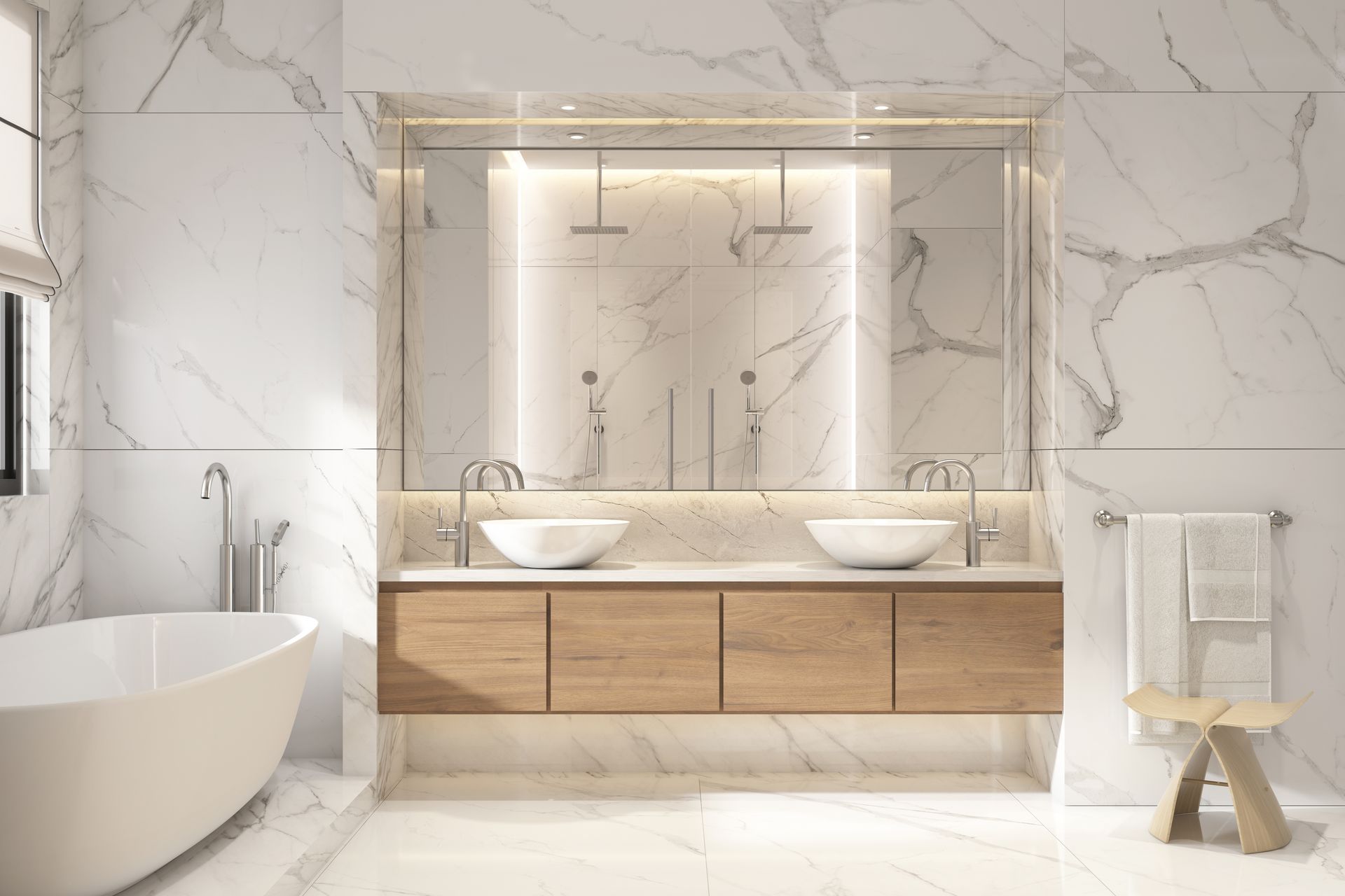 A modern white marble bathroom with a white tub, mirror, and wooden cabinet sink.