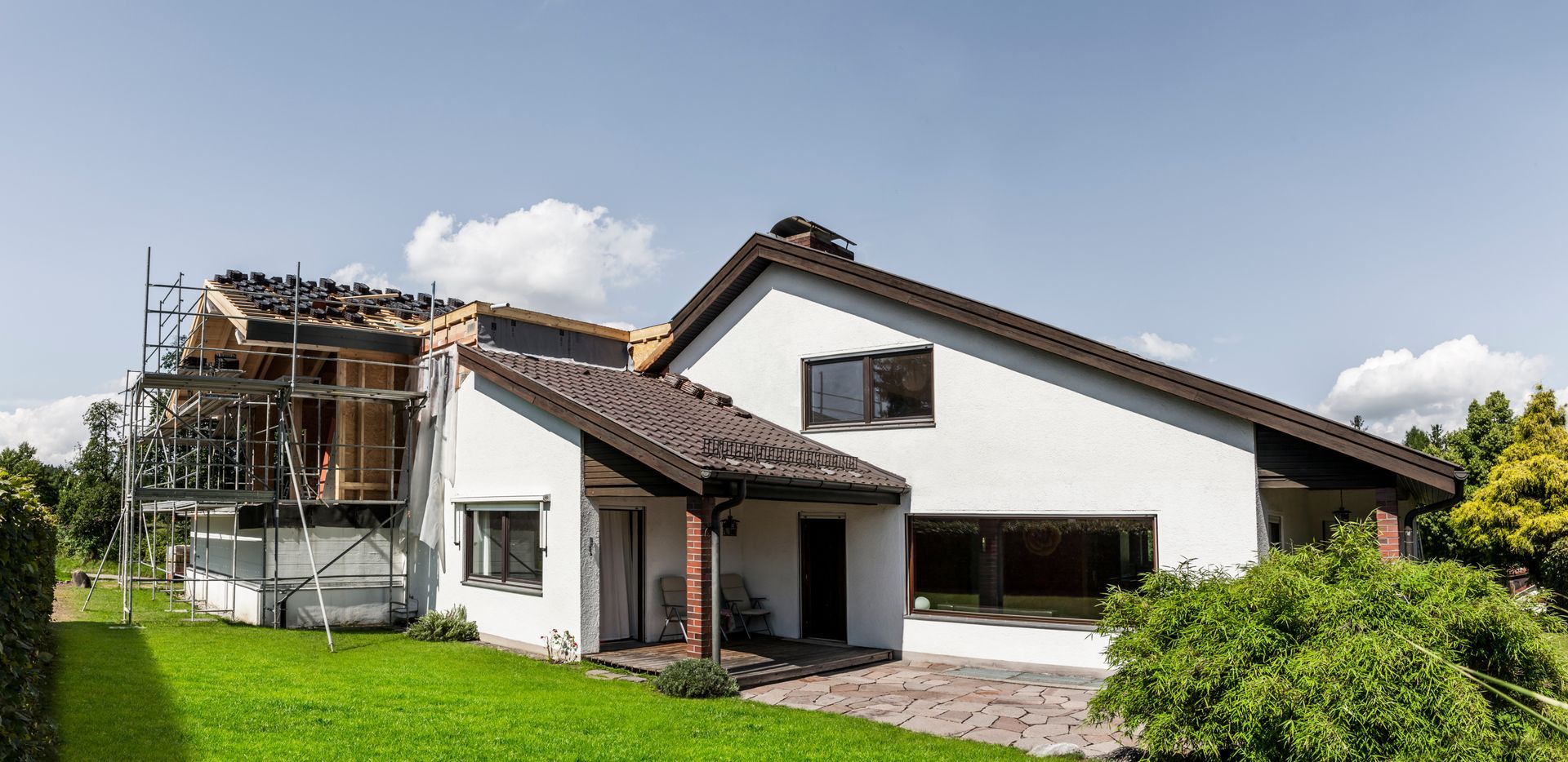 Outside view of a house in the middle of getting a new extension. Outside view of a house in the middle of getting a new extension.