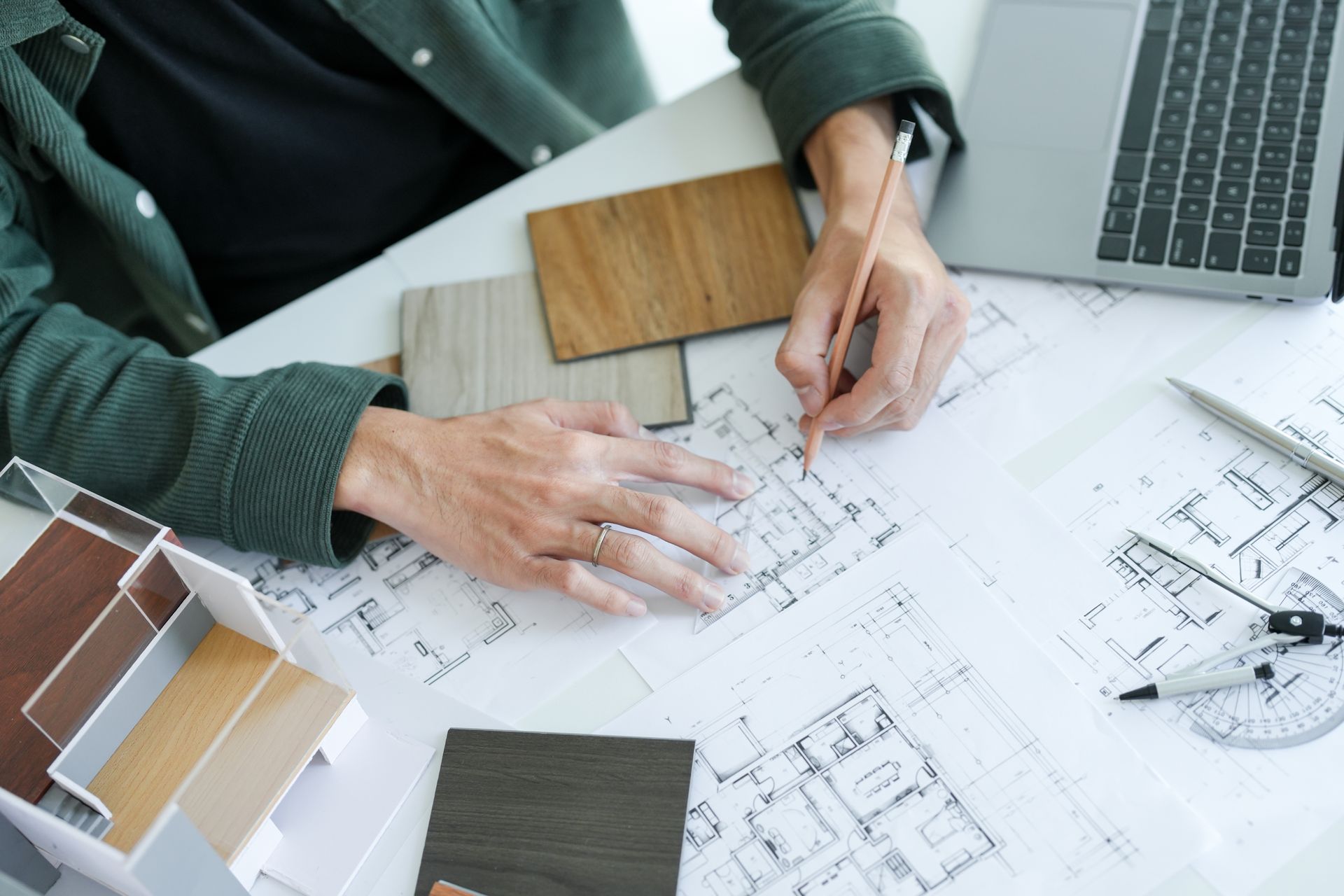A builder picking interior materials by using a blueprint.