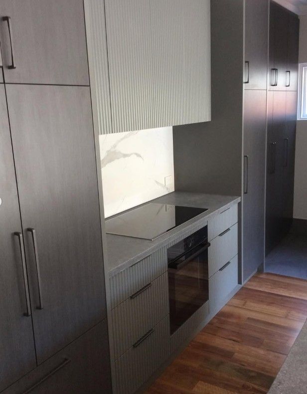 Modern cabinetry with textured panels and light wood finishes