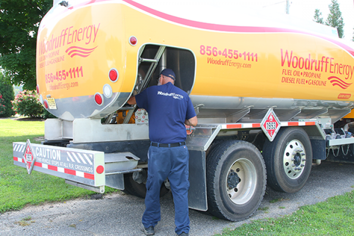 A man is working on a woodruff energy truck