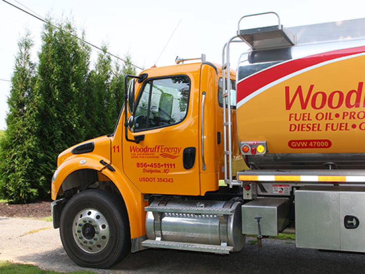 A woodruff energy fuel oil truck is parked in a driveway