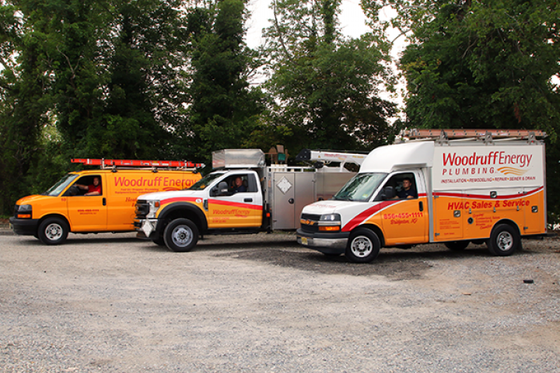 Two woodruff energy vans are parked next to each other