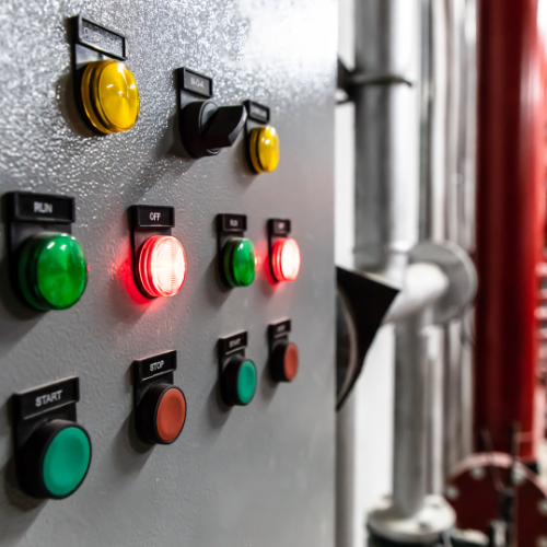 A control panel with a lot of buttons and lights on it.