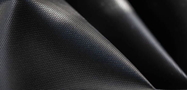 Close-up of textured black fabric with a grid pattern.