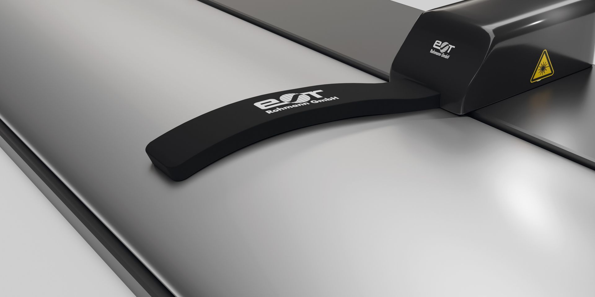 A black strap is sitting on top of a gray surface.