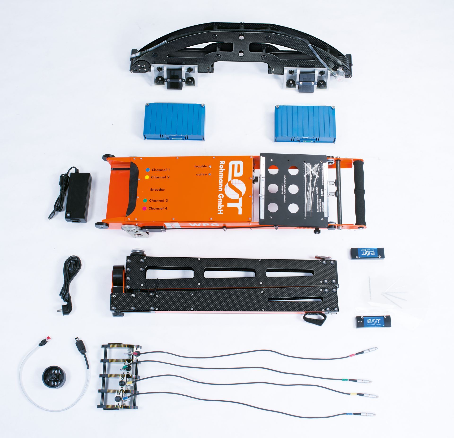 A bunch of electronics are laid out on a table including a box that says est