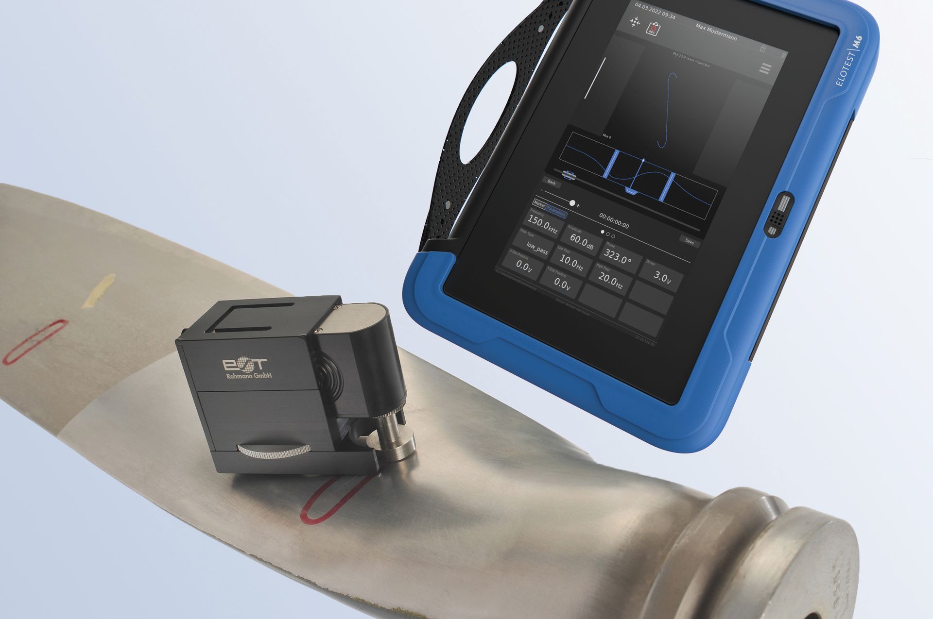 A blue tablet is sitting on top of a piece of metal.