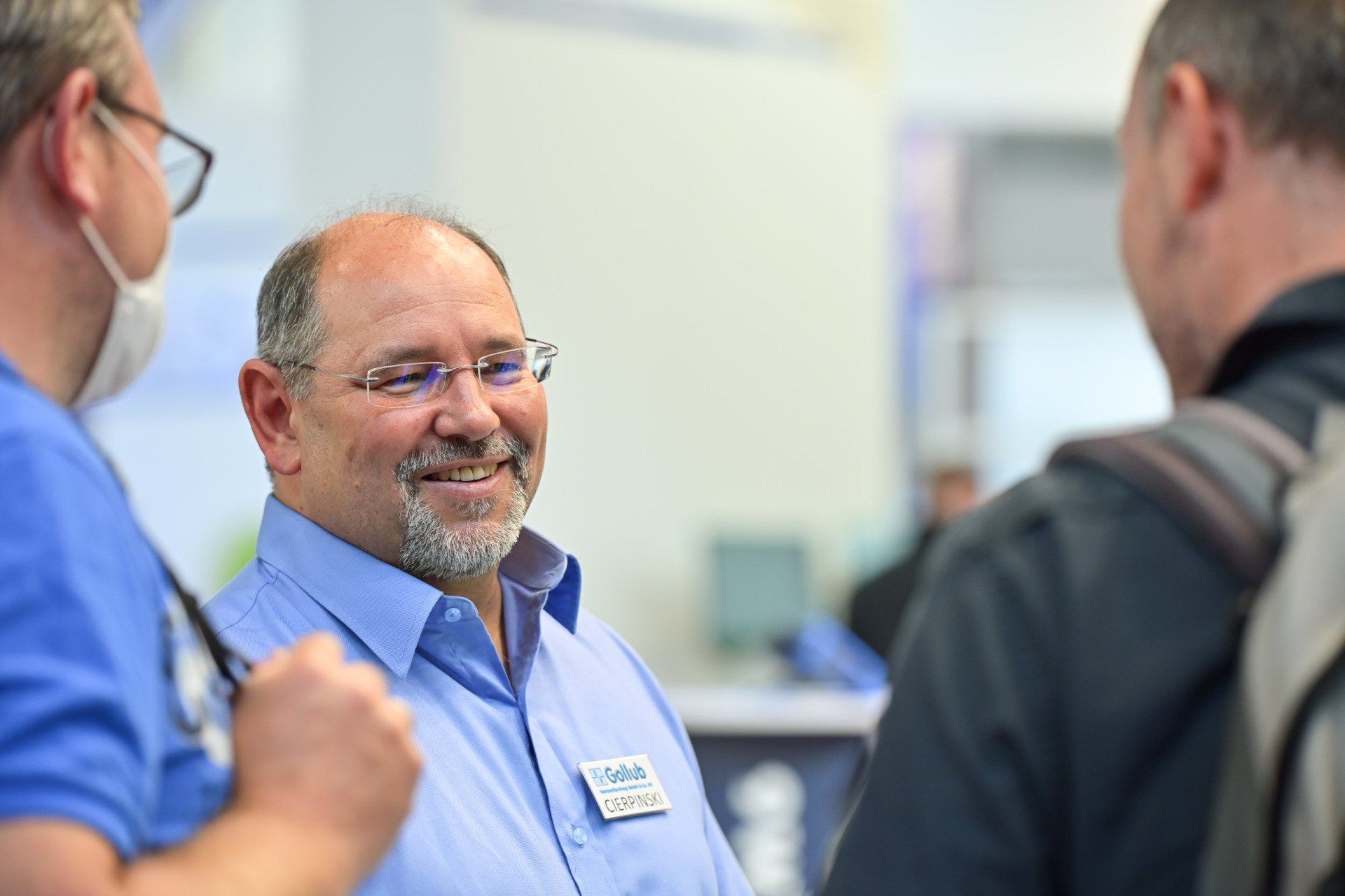 A group of men are talking to each other in a room.