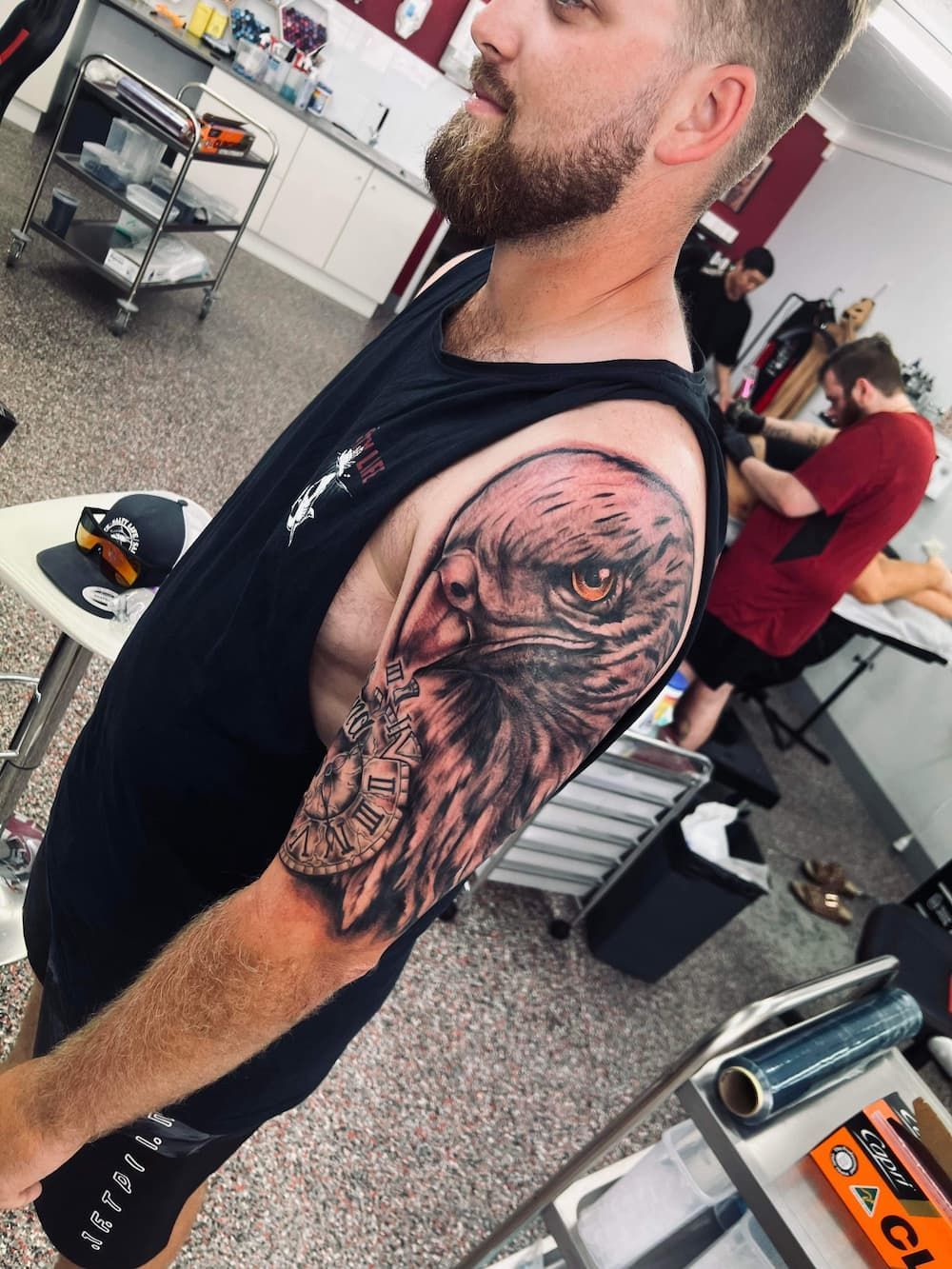 a man with a tattoo of an eagle on his arm - Tattoo Studio in Kawana, QLD