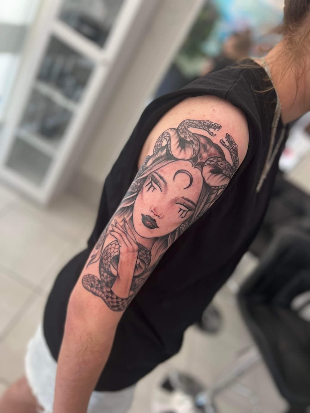 a woman has a medusa tattoo on her arm - Tattoo Studio in Kawana, QLD